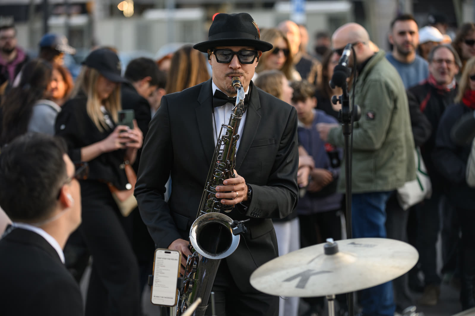 Saxophonist performing at a public music event in Plaça Catalunya